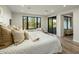 Spacious bedroom has a cozy bed, large windows, and a sliding door that leads to a balcony at 6500 E Camelback Rd # 1010, Scottsdale, AZ 85251