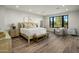 Bright bedroom has a comfortable bed, a bench, and a large window showcasing an outdoor view at 6500 E Camelback Rd # 1010, Scottsdale, AZ 85251