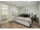 Cozy bedroom featuring hardwood floors, neutral tones, and plush bedding for a peaceful and inviting retreat at 6500 E Camelback Rd # 1010, Scottsdale, AZ 85251