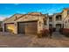 Charming home featuring a stone-accented two-car garage and beautiful landscaping at 6500 E Camelback Rd # 1010, Scottsdale, AZ 85251