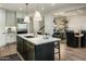 Modern kitchen featuring an island with marble countertops, pendant lighting, and stainless steel appliances at 6500 E Camelback Rd # 1010, Scottsdale, AZ 85251