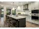 Bright kitchen boasting an island with counter seating, white cabinetry, and modern stainless appliances at 6500 E Camelback Rd # 1010, Scottsdale, AZ 85251