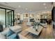 Open living space with hardwood floors, stylish furniture, and seamless access to the kitchen and dining areas at 6500 E Camelback Rd # 1010, Scottsdale, AZ 85251