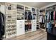 Spacious walk-in closet with custom shelving, drawers, and ample storage space for clothes, shoes, and accessories at 6500 E Camelback Rd # 1010, Scottsdale, AZ 85251