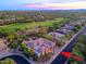 Beautiful aerial view of neighborhood home with desert landscaping and community golf course at 6591 E Amber Sun Dr, Scottsdale, AZ 85266