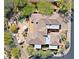 Aerial view of the property featuring a pool, patio, and lush landscaping at 6591 E Amber Sun Dr, Scottsdale, AZ 85266