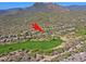 Aerial view of home near golf course, nestled in desert landscape with mountain backdrop at 6591 E Amber Sun Dr, Scottsdale, AZ 85266