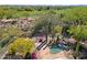 Elevated view of landscaped backyard oasis including pool, waterfall, and desert landscape at 6591 E Amber Sun Dr, Scottsdale, AZ 85266