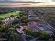 Panoramic aerial view of the neighborhood home and lush community golf course and desert landscape at 6591 E Amber Sun Dr, Scottsdale, AZ 85266