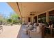 Inviting covered patio with wicker furniture, overlooking a beautifully landscaped yard at 6591 E Amber Sun Dr, Scottsdale, AZ 85266