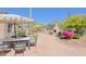 Expansive backyard patio featuring outdoor seating, desert landscaping, and a charming fireplace, perfect for entertaining at 6591 E Amber Sun Dr, Scottsdale, AZ 85266