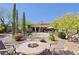 Resort-style backyard featuring a pool, fire pit, desert plants, and outdoor seating, perfect for relaxation and entertainment at 6591 E Amber Sun Dr, Scottsdale, AZ 85266