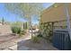 Beautiful backyard featuring desert landscaping, a built-in grill, fireplace, patio dining, and mature trees at 6591 E Amber Sun Dr, Scottsdale, AZ 85266