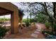 The backyard has desert landscaping with a stepping stone pathway at 6591 E Amber Sun Dr, Scottsdale, AZ 85266