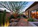 Beautiful backyard desert landscaping with stepping stone pathway leading to an outdoor kitchen at 6591 E Amber Sun Dr, Scottsdale, AZ 85266