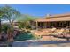 Stunning backyard with pool and spa, desert landscaping, and a patio lounge area at 6591 E Amber Sun Dr, Scottsdale, AZ 85266
