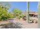 Picturesque backyard featuring desert landscaping, native plants, and a stone walkway leading to a pool at 6591 E Amber Sun Dr, Scottsdale, AZ 85266