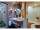 Modern bathroom with trough sink, unique vanity, and an open shower at 6591 E Amber Sun Dr, Scottsdale, AZ 85266