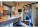 Stylish bathroom featuring a trough sink, unique vanity, and contemporary mirrors at 6591 E Amber Sun Dr, Scottsdale, AZ 85266