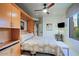Bedroom featuring a ceiling fan and a cozy bed integrated with built-in cabinets at 6591 E Amber Sun Dr, Scottsdale, AZ 85266