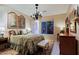 Cozy bedroom with decorative chandelier, bedside tables, and plush bedding at 6591 E Amber Sun Dr, Scottsdale, AZ 85266