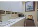 Butler's pantry with built-in shelves, coffee machine, and small refrigerator at 6591 E Amber Sun Dr, Scottsdale, AZ 85266