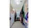 Walk-in closet providing ample storage with built-in shelves and a variety of hanging clothes at 6591 E Amber Sun Dr, Scottsdale, AZ 85266