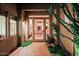 Inviting front entrance with decorative iron door and desert landscaping at 6591 E Amber Sun Dr, Scottsdale, AZ 85266