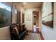 Inviting hallway with natural light, bench seating, and seamless transition to living spaces at 6591 E Amber Sun Dr, Scottsdale, AZ 85266