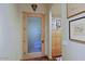 Hallway with natural wood trim and door with views to living room at 6591 E Amber Sun Dr, Scottsdale, AZ 85266