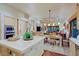 Bright kitchen with custom cabinets, stainless oven appliances, and large island at 6591 E Amber Sun Dr, Scottsdale, AZ 85266