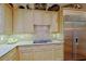Bright kitchen features custom cabinets, stainless appliances, and gas cooktop at 6591 E Amber Sun Dr, Scottsdale, AZ 85266