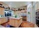 Bright kitchen features custom cabinets, stainless appliances, and large island with stone counters at 6591 E Amber Sun Dr, Scottsdale, AZ 85266
