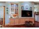 Living room features custom cabinets, media center and decorative insets at 6591 E Amber Sun Dr, Scottsdale, AZ 85266