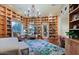 Open main bedroom boasts hardwood floors, built in shelving, sitting area and view of the property at 6591 E Amber Sun Dr, Scottsdale, AZ 85266