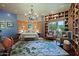 Spacious main bedroom with hardwood floors, unique chandelier, custom wood shelving, and designer area rug at 6591 E Amber Sun Dr, Scottsdale, AZ 85266