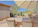 Outdoor dining area with seating and umbrella, perfect for enjoying meals in the desert landscape at 6591 E Amber Sun Dr, Scottsdale, AZ 85266