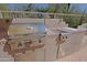 Built-in outdoor kitchen with stainless steel grill, ideal for summer barbecues and outdoor dining at 6591 E Amber Sun Dr, Scottsdale, AZ 85266