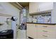 Utility room with water softener, water heater, and storage cabinets at 6591 E Amber Sun Dr, Scottsdale, AZ 85266