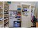 Bright walk-in closet with custom shelving, cabinets, and multiple storage options at 6591 E Amber Sun Dr, Scottsdale, AZ 85266