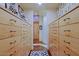 Spacious walk-in closet with custom built-ins, drawers, and ample storage space at 6591 E Amber Sun Dr, Scottsdale, AZ 85266