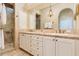 Bathroom with dual sinks, stone countertops, decorative mirror, and glass shower at 7222 E Gainey Ranch Rd # 106, Scottsdale, AZ 85258