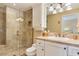 Well-lit bathroom with glass shower, sink, and tile flooring at 7222 E Gainey Ranch Rd # 106, Scottsdale, AZ 85258