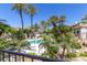 Stunning community pool surrounded by palm trees, lush plants, and desert landscape at 7222 E Gainey Ranch Rd # 106, Scottsdale, AZ 85258