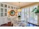 Bright dining room with round table, stylish chairs, and decorative wall mirror at 7222 E Gainey Ranch Rd # 106, Scottsdale, AZ 85258