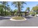 Community entrance with palm trees, flower beds, and plenty of parking for visitors at 7222 E Gainey Ranch Rd # 106, Scottsdale, AZ 85258