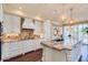 Modern kitchen featuring a granite island, updated appliances, and warm pendant lighting at 7222 E Gainey Ranch Rd # 106, Scottsdale, AZ 85258