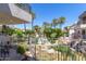 Beautiful patio and balcony views of pool, lush landscaping, and waterfall feature at 7222 E Gainey Ranch Rd # 106, Scottsdale, AZ 85258