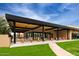 An expansive outdoor patio offering an abundance of seating, manicured lawn, and a shaded dining space at 7222 E Gainey Ranch Rd # 106, Scottsdale, AZ 85258