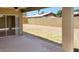 Covered patio opens to a spacious backyard with a block fence for privacy at 7506 W Devonshire Ave, Phoenix, AZ 85033